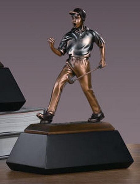Golfer after making winning shot makes a dramatic pose Sculpture